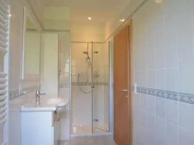 a bathroom with a shower and a sink and a shower at Apartment Moderne Ferienwohnung mit Balkon und Pool by Interhome in Merano