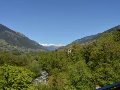 a river in a valley with mountains in the background at Apartment Moderne Ferienwohnung mit Balkon und Pool by Interhome in Merano