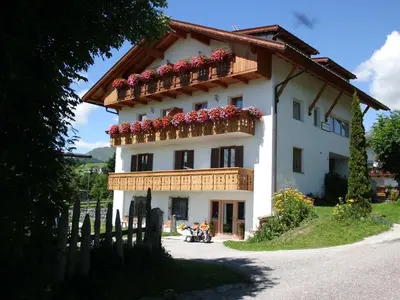 a large white building with flowers on the balcony at Apartment Rosenheim Appartement 4 by Interhome in Maranza