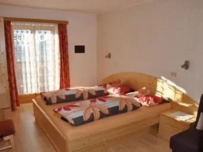 a bedroom with a bed and a window at Apartment Rosenheim Appartement 4 by Interhome in Maranza