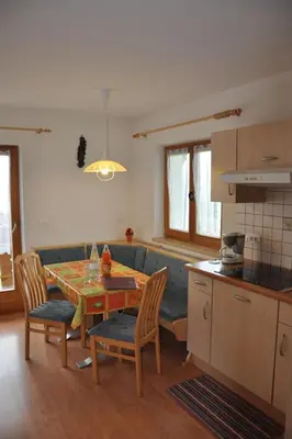 a kitchen and living room with a table and a couch at Apartment Rosenheim Appartement 4 by Interhome in Maranza