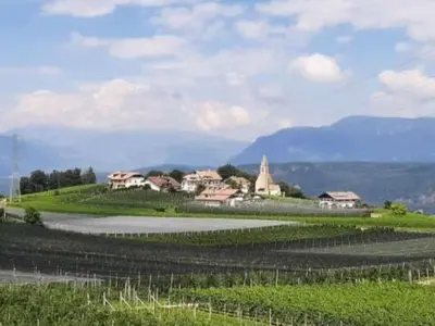 a village on top of a green hill with houses at Apartment Bergblick by Interhome in Castelvecchio