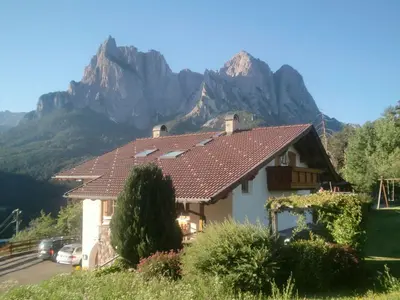 a house with a mountain in the background at Apartment in Seis by Interhome in Siusi