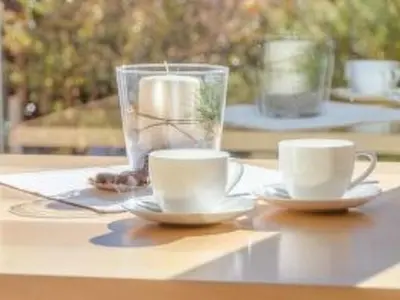 two coffee cups and a vase on a table at Apartment in Seis by Interhome in Siusi