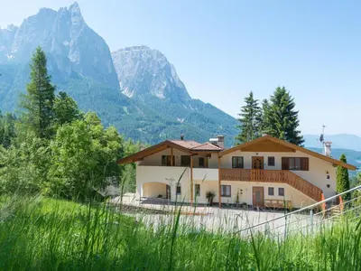a house with a mountain in the background at Apartment Wohnung in den Dolomiten mit traumhafter Aussicht by Interhome in Kastelruth