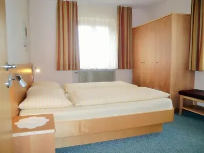 a bedroom with a large bed with a window at Apartment Wohnung in den Dolomiten mit traumhafter Aussicht by Interhome in Kastelruth