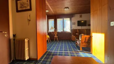 a room with a hallway with a living room at Apartment in the center of Cortina with private garage in Cortina dʼAmpezzo