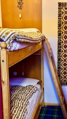 a bunk bed in a room with a bunk bedutenewayangering at Apartment in the center of Cortina with private garage in Cortina dʼAmpezzo