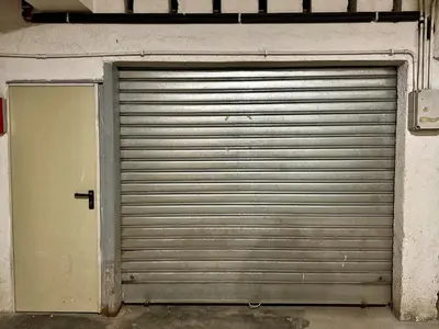 a large metal garage door in a building at Apartment in the center of Cortina with private garage in Cortina dʼAmpezzo