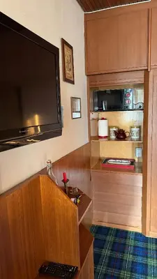 a room with a large flat screen tv on the wall at Apartment in the center of Cortina with private garage in Cortina dʼAmpezzo