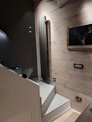 a set of stairs in a room with a mirror at VHĀUS Apartment and Spa in Predazzo