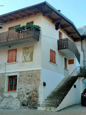 a building with a staircase on the side of it at appartamento Casa Lucia in Cencenighe