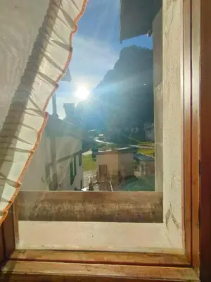 an open window with a view of a city at appartamento Casa Lucia in Cencenighe