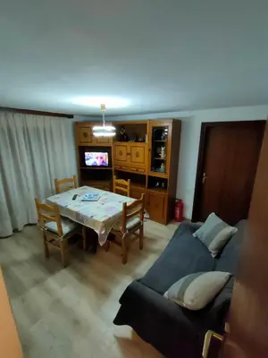 a living room with a table and a couch at appartamento Casa Lucia in Cencenighe