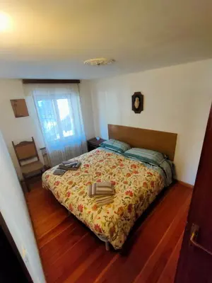 a bedroom with a bed with a book on it at appartamento Casa Lucia in Cencenighe