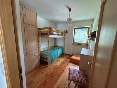 a bedroom with a bunk bed and a window at Ca' San Lorenzo in Villanova