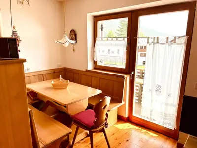 a dining room with a wooden table and a window at Ca' San Lorenzo in Villanova