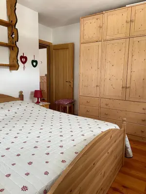 a bedroom with a large bed and wooden cabinets at Ca' San Lorenzo in Villanova