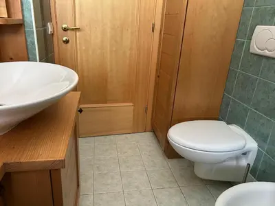a bathroom with a white toilet and a sink at Ca' San Lorenzo in Villanova