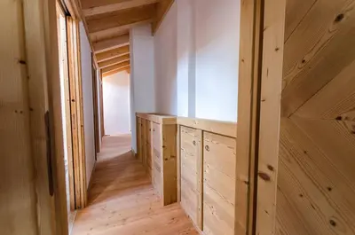 a hallway in a house with wooden walls and wooden floors at Elegante Appartamento a Cortina in Cortina dʼAmpezzo