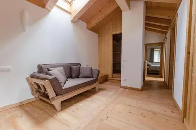 a living room with a couch on a wooden floor at Elegante Appartamento a Cortina in Cortina dʼAmpezzo