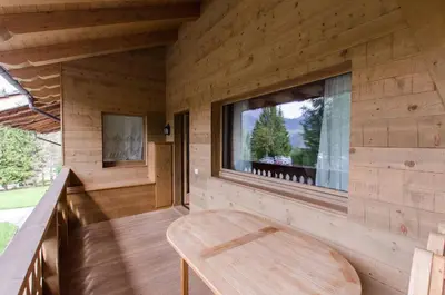 a wooden room with a bench and a window at Elegante Appartamento a Cortina in Cortina dʼAmpezzo