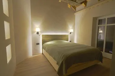 a bedroom with a large bed in a room at Sky Loft at Cervo - Panoramic Penthouse in Moena in Moena