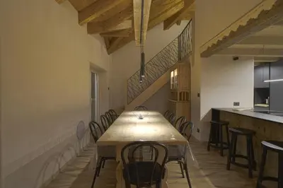 a dining room with a table and some chairs at Sky Loft at Cervo - Panoramic Penthouse in Moena in Moena