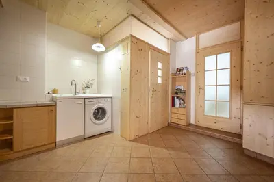 a kitchen with a washing machine and a window at Apartments Romy in Ortisei