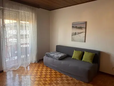 a living room with a couch and a window at Casa Iris in Laives