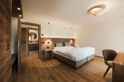 a bathroom with a shower and a bath tub at Ciasa Bel Marin in La Villa