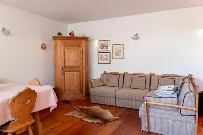 a living room with a couch and a table at Casa Rita Brenta - Ruffrè-Mendola in Ronzone