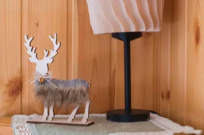 a lamp and a statue of a reindeer on a table at Chalet Salejada - WiFi comfort and elegance in Moena