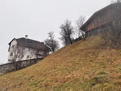 a house on top of a grassy hill at Agriturismo Ciastel de Brach in Longega