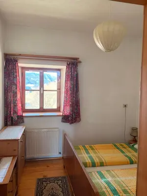 a bedroom with two beds and a window at Agriturismo Ciastel de Brach in Longega