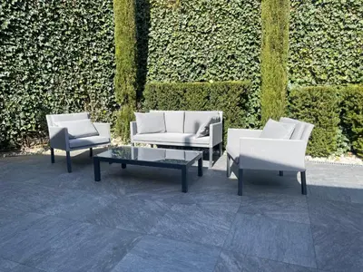 three chairs and a coffee table in front of a wall at Premium Apartments Faselehof in Marlengo