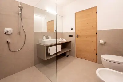 a bathroom with a shower and a sink and a toilet at Premium Apartments Faselehof in Marlengo