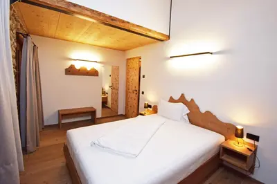 a bedroom with a large white bed in a room at Aurturist Moar - San Lorenzo di Sebato in Floronzo