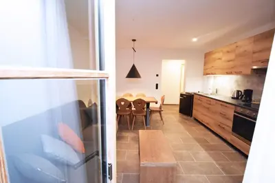 a kitchen with a table and a dining room at Aurturist Moar - San Lorenzo di Sebato in Floronzo