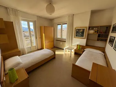 a bedroom with two beds and a window at A Due Passi dalle Piste in Cavalese