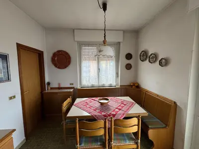 a dining room with a table and chairs in a room at A Due Passi dalle Piste in Cavalese