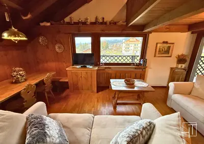 a living room with a couch and a table at HT - Chalet panoramico con vista sulle Dolomiti in San Vito di Cadore