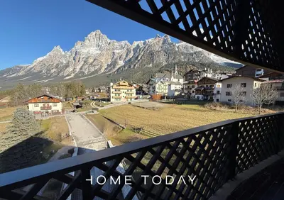 a view from a balcony of a town with a mountain at HT - Chalet panoramico con vista sulle Dolomiti in San Vito di Cadore