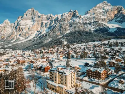 a city covered in snow with mountains in the background at HT - Chalet panoramico con vista sulle Dolomiti in San Vito di Cadore