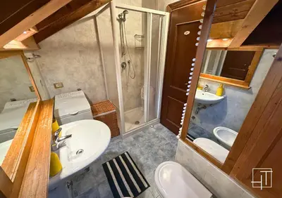 a small bathroom with a sink and a shower at HT - Chalet panoramico con vista sulle Dolomiti in San Vito di Cadore