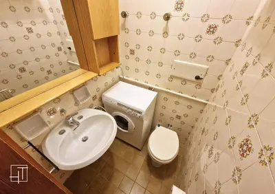 a small bathroom with a sink and a toilet at HT - Ciasa Ca' Novella nel cuore delle Dolomiti in San Vito di Cadore