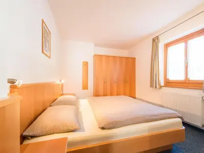 a bedroom with a bed and a window at Apartment mit traumhaftem Ausblick by Interhome in Siusi