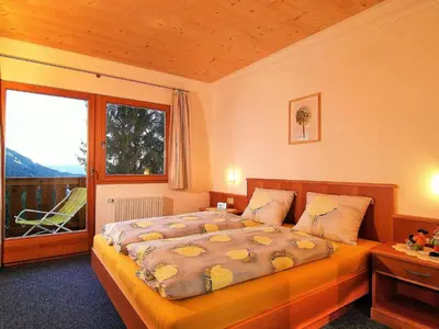 a bedroom with a bed and a large window at Apartment mit traumhaftem Ausblick by Interhome in Siusi