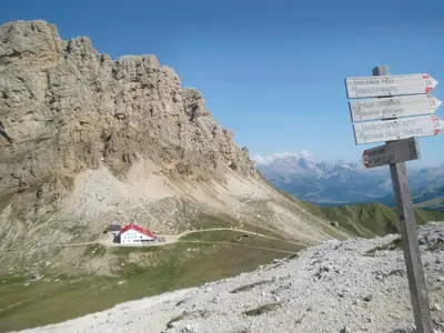 a sign on the side of a mountain with a house at Apartment mit traumhaftem Ausblick by Interhome in Siusi