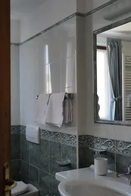 a bathroom with a sink and a mirror at Luxury Chalet at the Foot of the Dolomites by the Castle in La Villa